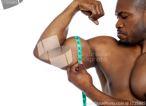 Image of Handsome guy measuring his biceps