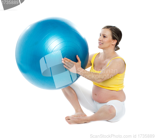 Image of Pregnant woman excercises with a gymnastic ball