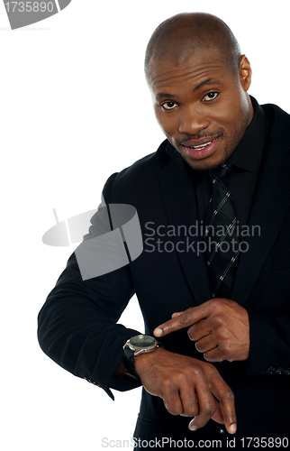 Image of African male indicating towards wrist watch