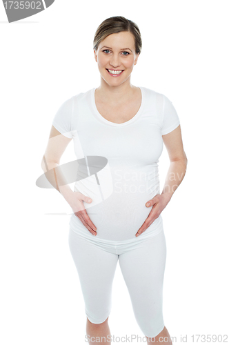 Image of Pregnant woman holding her tummy