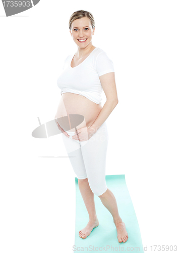 Image of Pregnant woman touching her belly