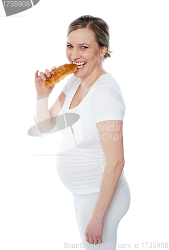 Image of Pretty pregnant lady eating fast food