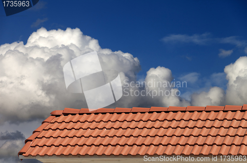 Image of Roof tiles and blue sky with clouds