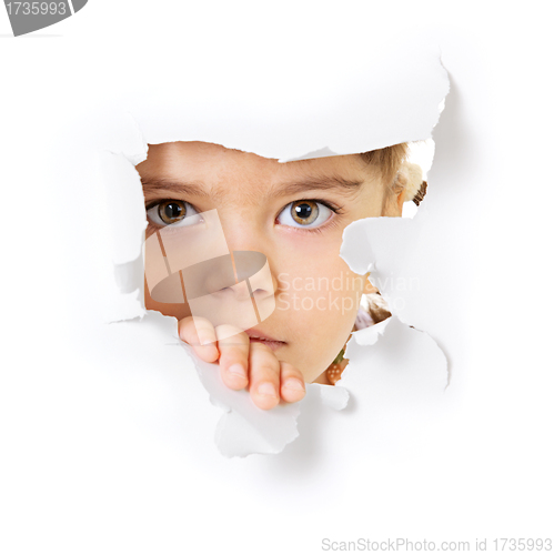 Image of Child's face looking through a hole in paper