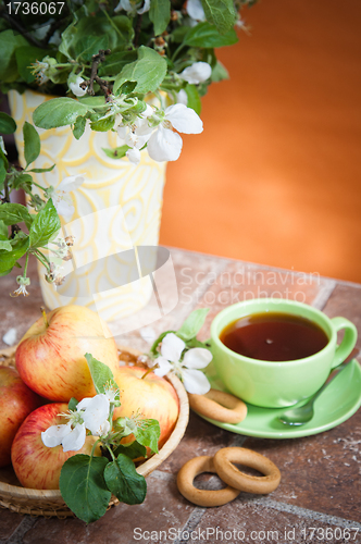 Image of Beautiful ripe apples and branches of a blossoming apple-tree in