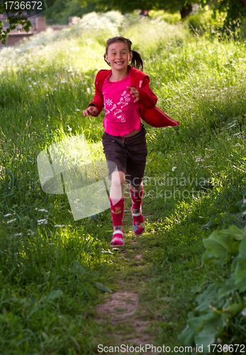 Image of Pretty young girl running in the park