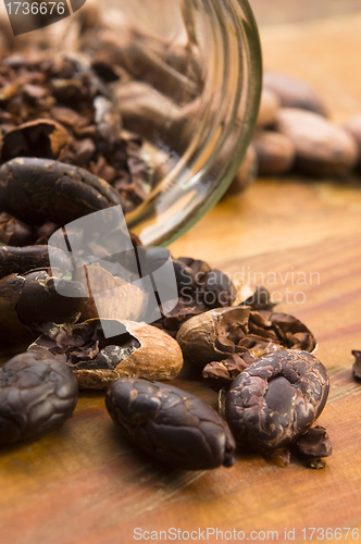 Image of Cocoa (cacao) beans on natural wooden table