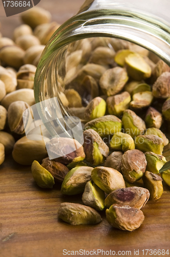 Image of Roasted pistachios on natural wooden table
