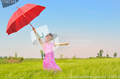 Image of teenage girl with red umbrella in wheat field