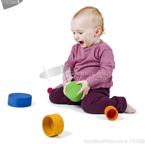 Image of young child playing with colorful toy blocks