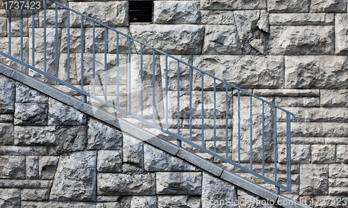 Image of stone wall with blue railings