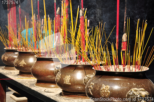 Image of Incense or joss sticks burning in jars