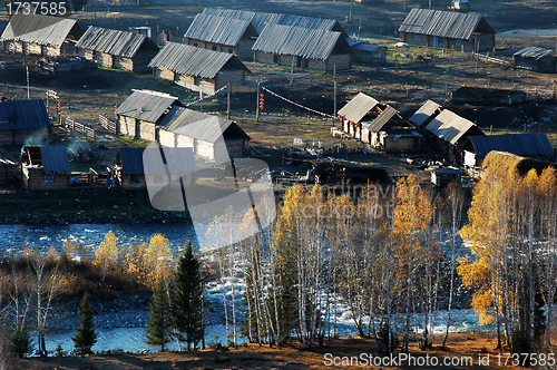 Image of Village with golden trees in autumn