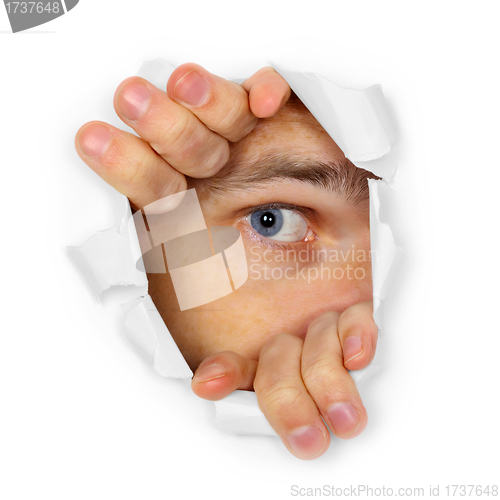 Image of Man watches through a hole