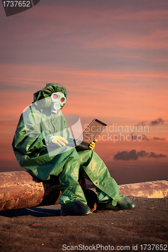 Image of Man in protective suit works in contamination area