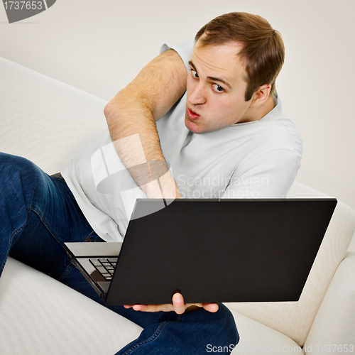 Image of Comic man plays on a laptop