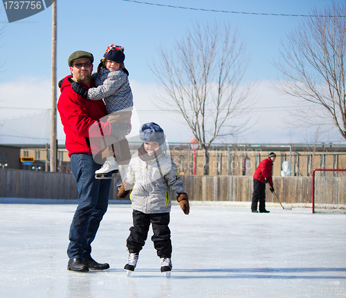 Image of Happy family at the skating rink