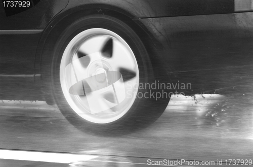 Image of sport car driving fast in a rainy day