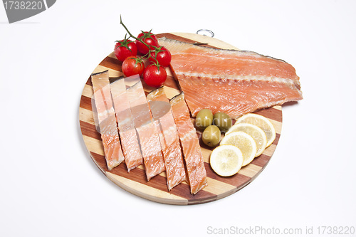 Image of fresh red fish fillet on wooden plate
