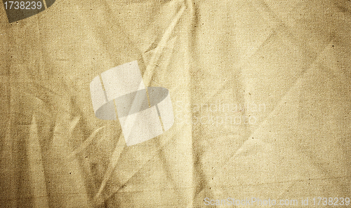 Image of Background of crumpled dense fabric colored in beige tones