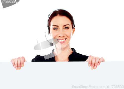 Image of Attractive help-desk female holding blank placard