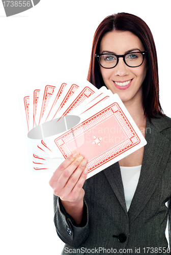 Image of A beautiful woman holding playing cards