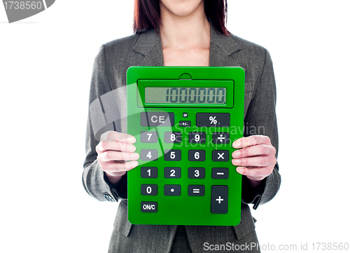Image of Business woman holding calculator. Focus on calculator
