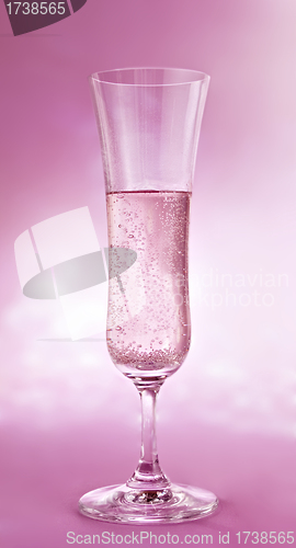 Image of a glass  of champagne on pink background