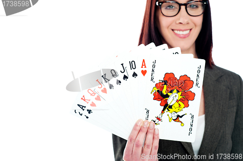 Image of Charming businesswoman holding playing cards