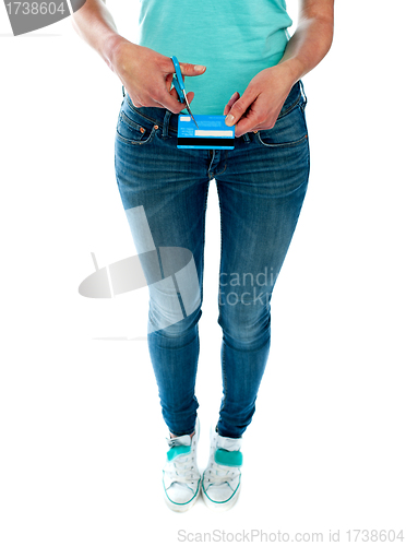 Image of Woman cutting credit card with scissors