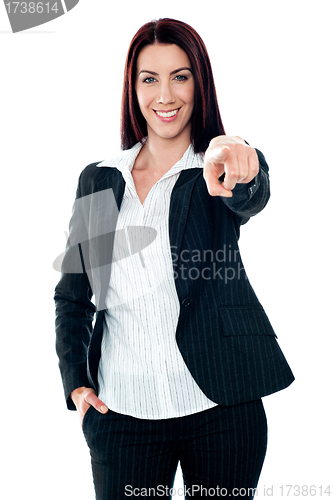 Image of Smiling corporate lady pointing at you