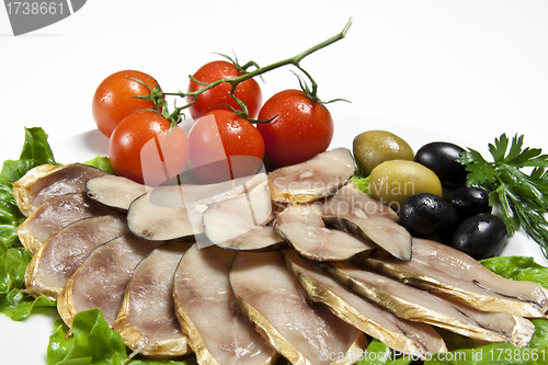 Image of slices smoked fish served with tomato and olive