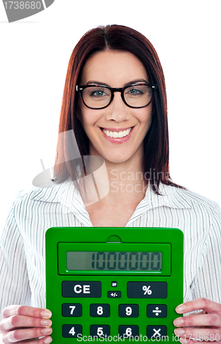 Image of Smiling corporate lady showing green calculator