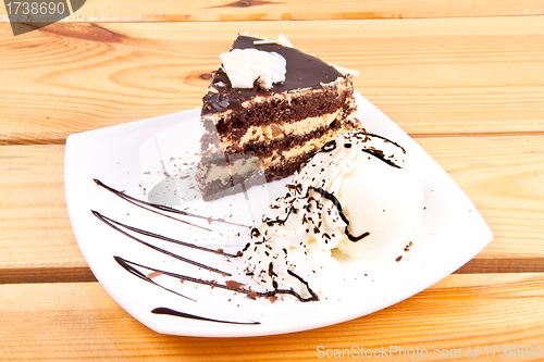 Image of Chocolate brownie with vanilla ice-cream and chocolate sauce