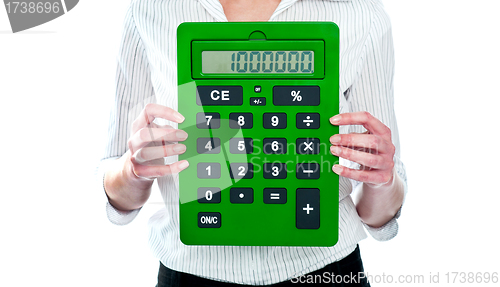 Image of Focus on green calculator. Woman holding