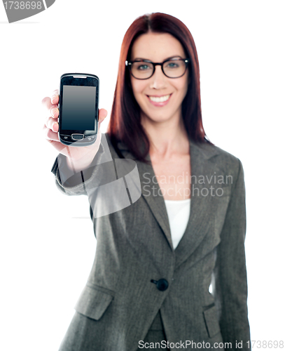 Image of Saleswoman displaying latest mobile handset