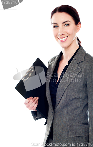 Image of Smiling female secretary holding clipboard