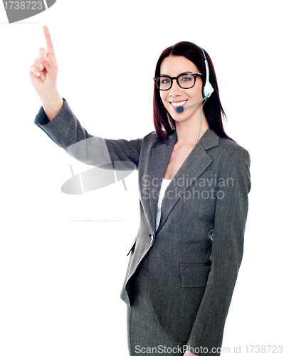 Image of Female executive pointing up at copyspace