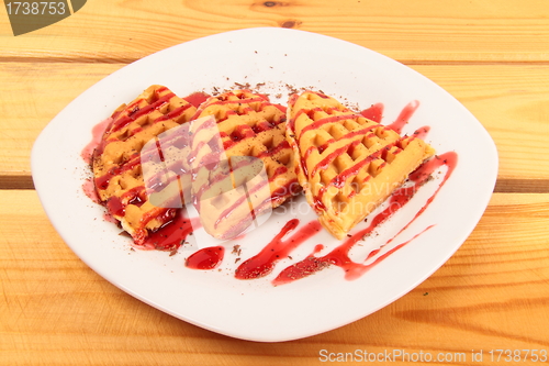 Image of Waffles with strawberry on wooden table