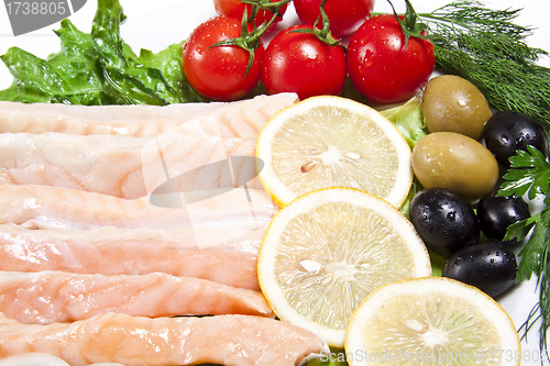 Image of raw red fish with lemon and olive
