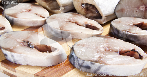 Image of nice slices fish and wooden plate