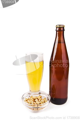 Image of Beer bottle with glass and salted peanuts isolated