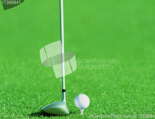 Image of Golf ball behind driver at driving range