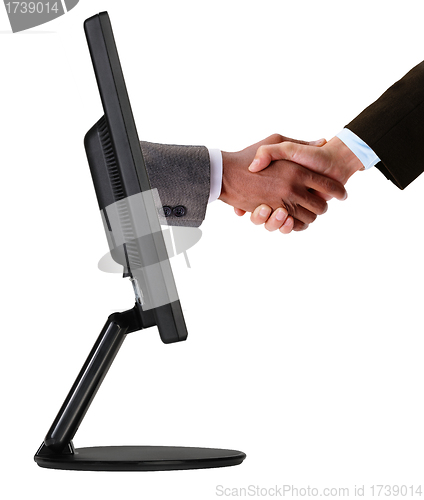 Image of Businessmen shaking hands out of TV screen