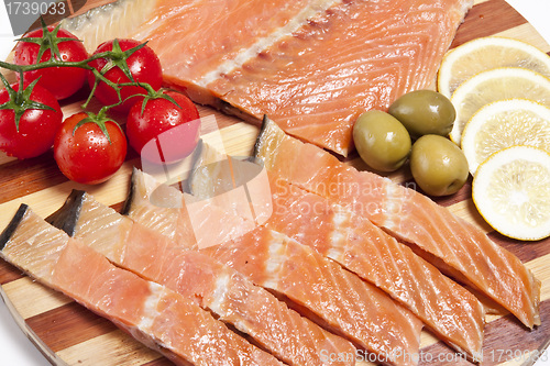 Image of close-up of smoked salmon on wooden plate