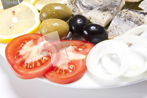 Image of slices fish and tomato slice with onion