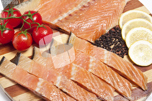 Image of close-up of smoked salmon  with tomato and lemon