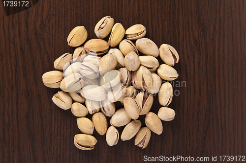Image of shelled pistachio on wooden