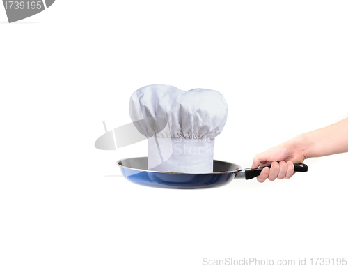 Image of chef hat on pan - concept