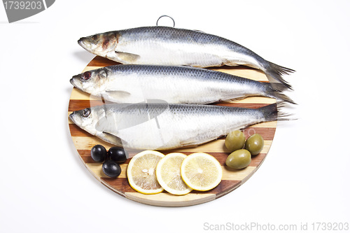 Image of Fish with lemon and olive on plate